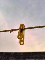 Flies hanging on a clothespin on a string. Blurred and bokeh background photo