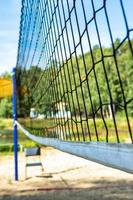 beach volleyball net against the blue sky on the beach, blurred focus photo