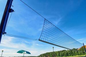 beach volleyball net against the blue sky on the beach photo