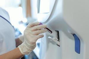 Blood hematology analyzer. Close up of medical worker in lab. photo