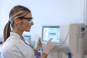 Female science intern analyzing DNA, RNA or blood samples for drug use results, disease and virus research photo