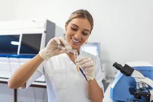 Modern Medical Research Laboratory  Female Scientist Working with Micro Pipette, Analysing Biochemicals Samples. Advanced Scientific Lab for Medicine, Microbiology Development. photo