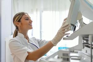 Research Scientists Working On Computer, with Medical Equipment, Analyzing Blood and Genetic Material Samples with Special Machines in the Modern Laboratory. photo