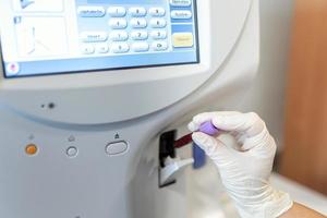 Blood haematology analyzer. Close up of medical worker in lab. photo