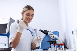 Modern Medical Research Laboratory Female Scientist Working with Micro Pipette, Analysing Biochemicals Samples. Advanced Scientific Lab for Medicine, Microbiology Development. photo