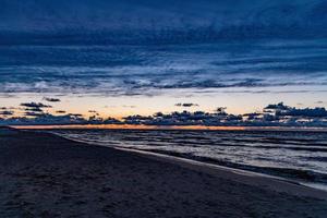 picturesque calm sunset with colorful clouds on the shores of the Baltic Sea in Poland photo