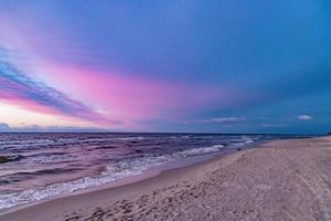 picturesque calm sunset with colorful clouds on the shores of the Baltic Sea in Poland photo