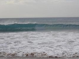 landscape of rough blue ocean and cloudless sky photo