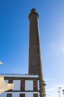 famous historic lighthouse in Maspalomas on the Spanish Canary Island of Gran Canaria a warm summer day, photo