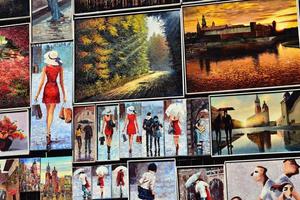 colorful reproductions of paintings hanging on the barbican on a warm summer day in Krakow in Poland photo