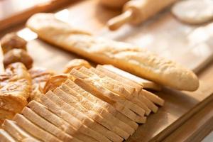 fresh bread and wheat on the wooden. Fresh fragrant bread on the table. Food concept. photo