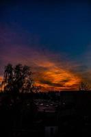 natural dramatic with clouds colorful urban sunset with construction crane photo