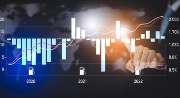 Oil energy graph of the world market, impact on the economic concept,Businessman touch chart with the indicator on the oil price slide at a gas station, fluctuations in oil prices and exchange trade. photo