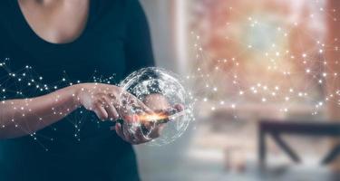 Woman using smartphone with global network connection. Internet communication, Wireless connection technology. Futuristic technology with polygonal shapes,Communication and marketing concept, photo