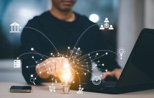 thinking and creative concept, Close up the light bulb and man working on the desk, Creativity, and innovation are keys to success,  new idea and innovation with Brain and light bulbs,big data photo