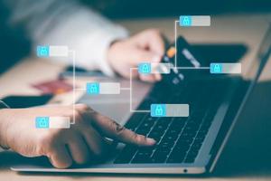 Hand using laptop and Visa card, Blockchain technology business hand working on laptop,Side view and close up of hand using laptop with social media icons. Communication and network concept. photo