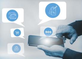 Close-up image of male hands using smartphone with icon, Customer support hotline Contact us people connection. Businessman using Smart Phone with the email, call phone, address, Chat message icons. photo