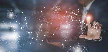 Businessman holding connections system and global data exchange. ,Business network connection concept. hologram screen displaying modern web system Wireless connection futuristic concept photo