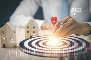 Targeting the business concept, Businessman throwing red arrow dart to virtual target dart board,Executive marketing, investment goal and target for business investment concept. photo