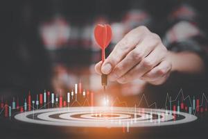 Targeting the business concept, Businessman touch red arrow dart to the virtual target dartboard, Executive marketing, investment goal and target for business investment concept, mini home. photo