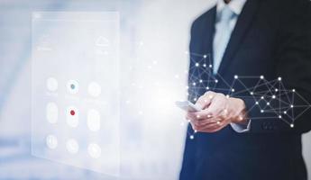Using the remote to connect electrical appliances concept, Businessman holding remote connecting channel and presses the button on the remote control. Remote control in hand closeup. photo