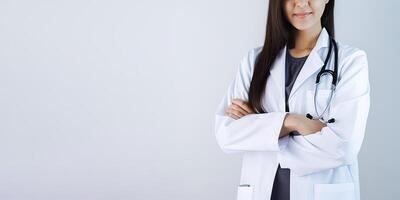 A woman doctor wearing a lab coat with a stethoscope with copy space. photo