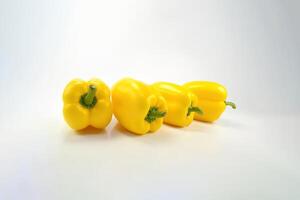 a group of yellow bell pepper isolated on white background. photo