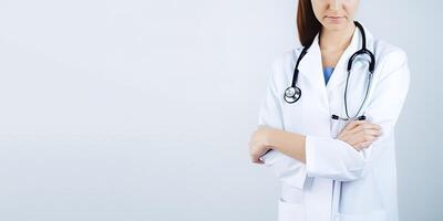 A woman doctor wearing a lab coat with a stethoscope with copy space. photo