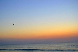 Sea Shore with Waves and Sunset photo