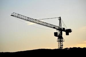 construcción grua y puesta de sol cielo en antecedentes foto