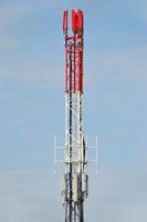 Red and White Telecommunication Mast with Antennas photo