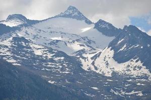 Rocky Peak of the Mountain Covered with Snow - Alps in Austria photo