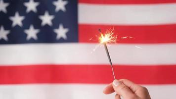 Sparkler against USA flag. Independence Day celebration, fourth of july video