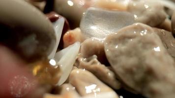 Close up macro video of stones and pebbles getting covered as the tide comes in