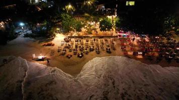 Beach restaurants with ocean waves in Sri Lanka, Mirissa by drone at evening video