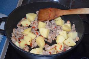 Meat and Potatoes Frying together photo