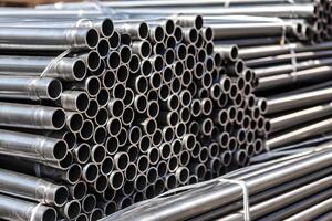 high quality Galvanized steel pipe or Aluminum and chrome stainless pipes in stack waiting for shipment in warehouse. Neural network AI generated photo