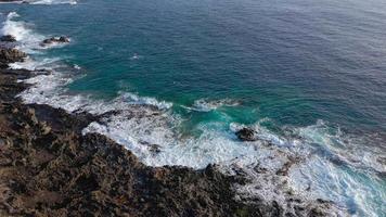 Top view of a deserted coast. Rocky shore of the island of Tenerife. Aerial drone footage of sea waves reaching shore video