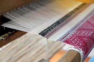 Woven fabrics with local patterns that are detailed, beautiful, meticulous and have meanings according to that local way of life. woven by hand loom. Soft and selective focus. photo