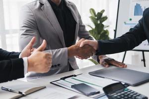 Cropped shot of professional business people having a hand shake after the meeting is over with a positive result. photo