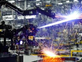 Modern High Tech Industrial Robotic arm on the factory production line production line is being welded. . photo