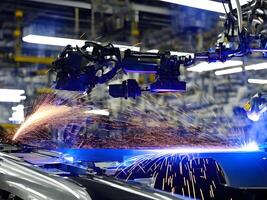 Modern High Tech Industrial Robotic arm on the factory production line production line is being welded. . photo
