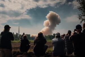 A group of people watch a rocket launch into space on the horizon, . photo