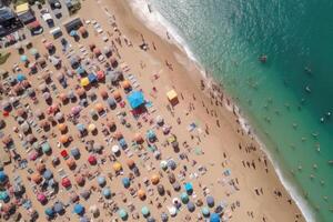 Sea beach with colorful umbrellas and relaxing people, top view. photo