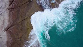 Top view of the desert beach on the Atlantic Ocean. Coast of the island of Tenerife. Aerial drone footage of sea waves reaching shore video