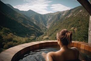 Back view of nacked woman relaxing in jacuzzi outdoors. photo