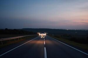 The drone flies at night on the road, illuminating with spotlights. . photo