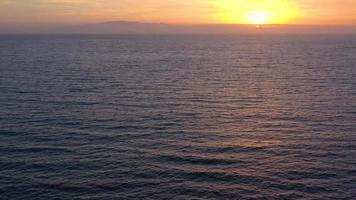 Aerial view of surface of the Atlantic Ocean with reflection of sunlight at sunset video