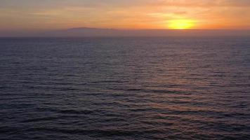 Aerial view of surface of the Atlantic Ocean with reflection of sunlight at sunset video