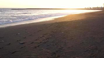 Aerial view of surface of the Atlantic Ocean with reflection of sunlight at sunset video